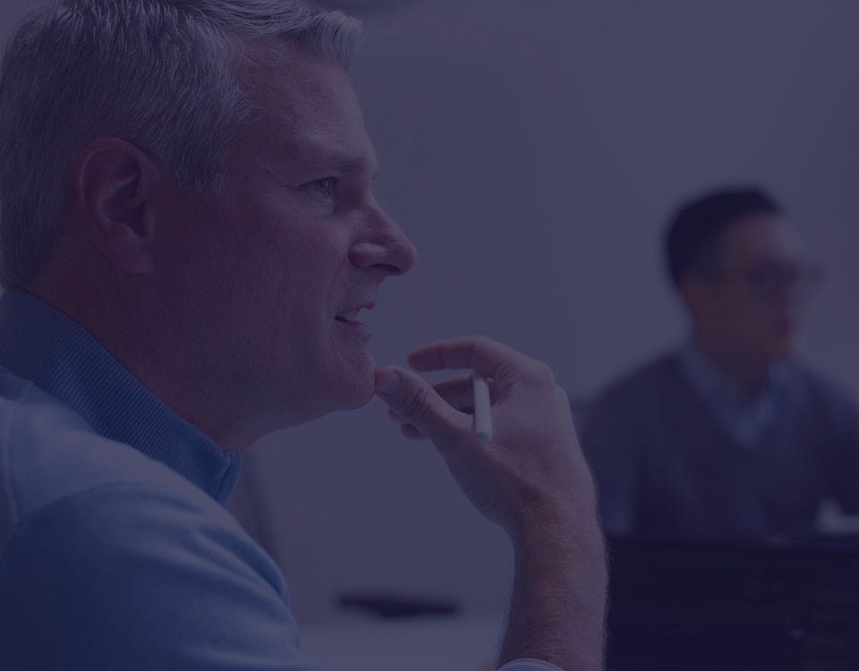 Side profile of a man listening intently during a meeting