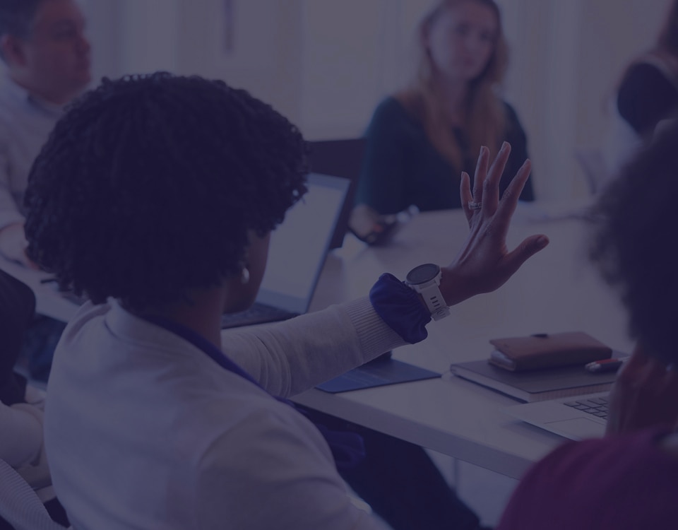 A group of people meeting in a conference room