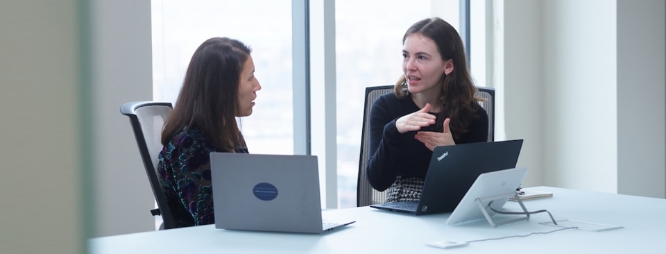 Two colleagues meeting in a conference room