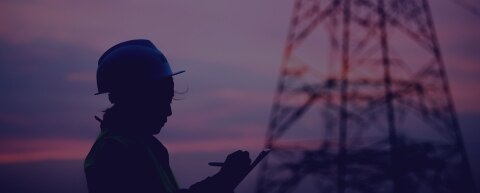 Shadow of a onsite worker with a power tower behind them