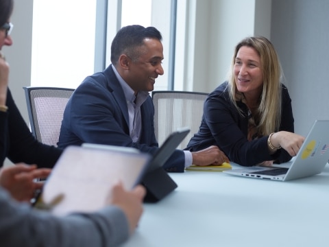 Two LMI employees chatting in a meeting
