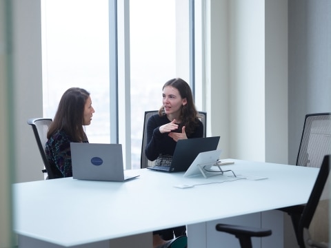 Two LMI team members chatting in a conference room