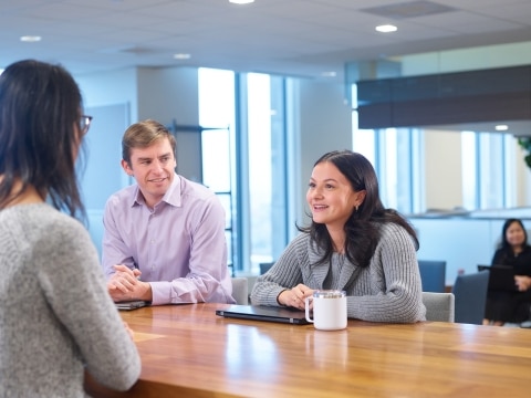 Group of LMI employees meeting in an open-plan office