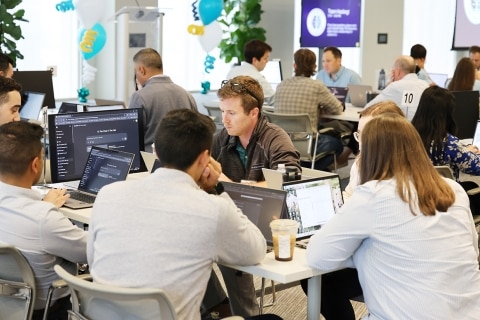 Group of people participating in a hackathon